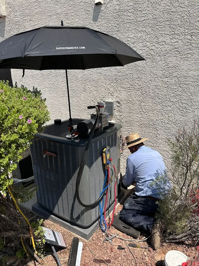 HVAC technician performing outdoor AC maintenance in Colesville